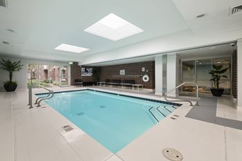 A large indoor swimming pool with a skylight above it.